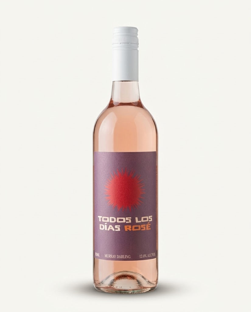 Todos Los Dias Rosé bottle, clear glass showing pink wine, white screwcap and purple label with a red sun